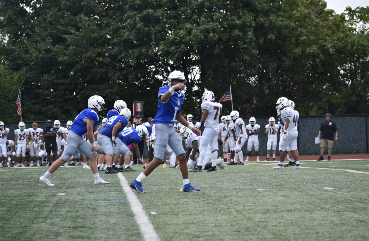 Varsity football wide receiver Tito Ruiz gets ready for the next play.